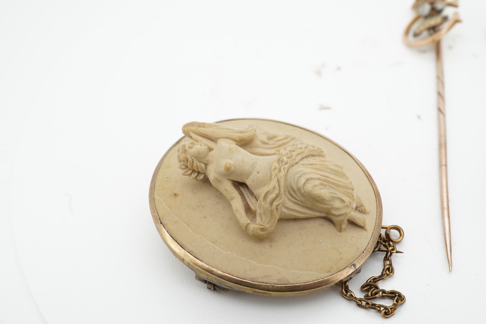 A collection of jewels, comprising: a stick pin, capped with the 'C' cipher with crowned ostrich feather and 'Ich Dien' motto for King Charles when Prince of Wales, in varicoloured gold and enamel, length 6.9cm, gross we